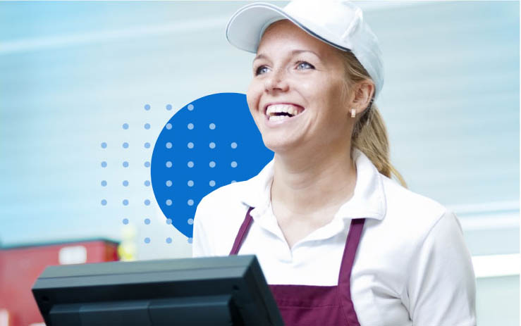 A cashier in a hat taking a fast food order using enterprise cloud POS